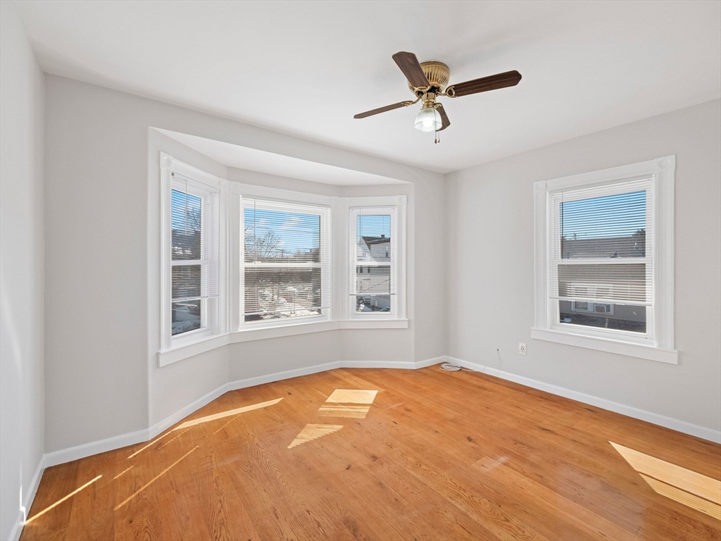 37 Howard Street Lynn, MA 01902 - Photo 32 of 42 a blue bed sitting in a bedroom next to a window