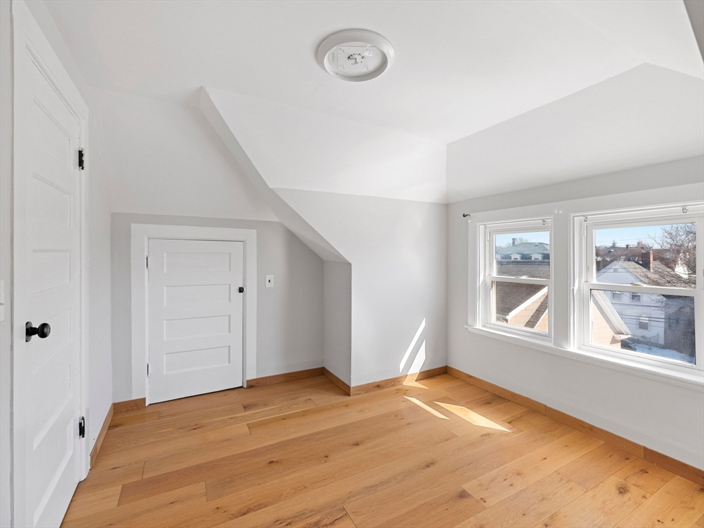 37 Howard Street Lynn, MA 01902 - Photo 38 of 42 an empty room with wooden floor and windows