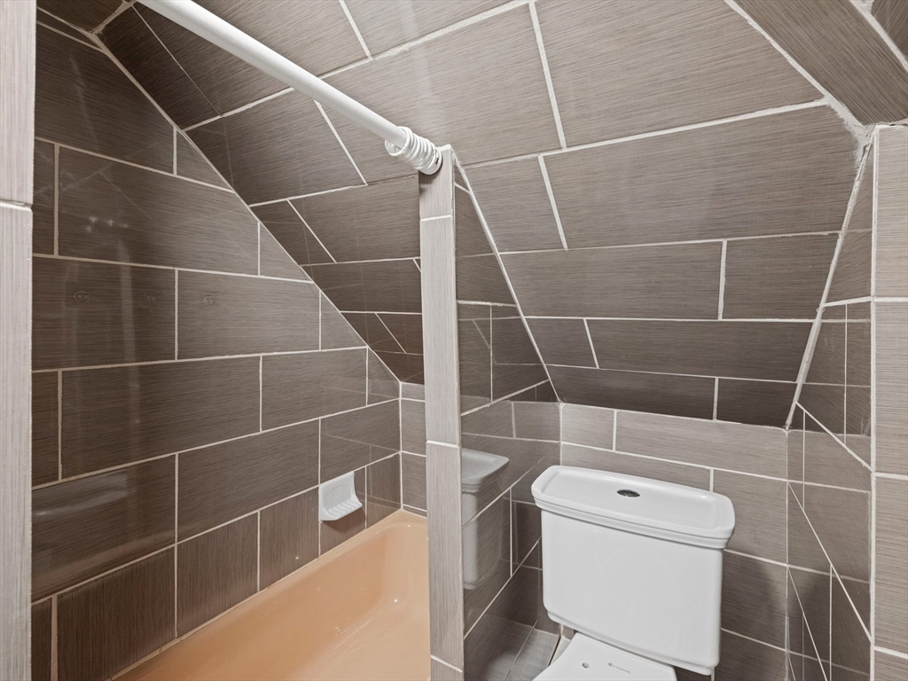 37 Howard Street Lynn, MA 01902 - Photo 41 of 42 a bathroom with a toilet and a shower