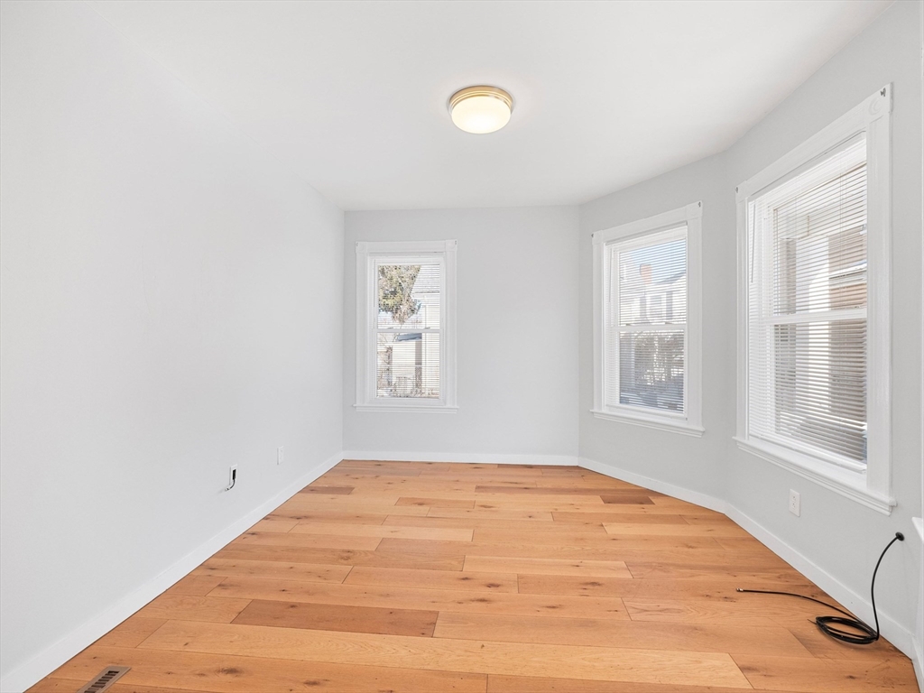 37 Howard Street Lynn, MA 01902 - Photo 6 of 42 a view of empty room with wooden floor and fan