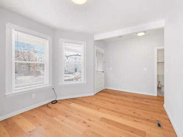 a kitchen with refrigerator cabinets and wooden floor