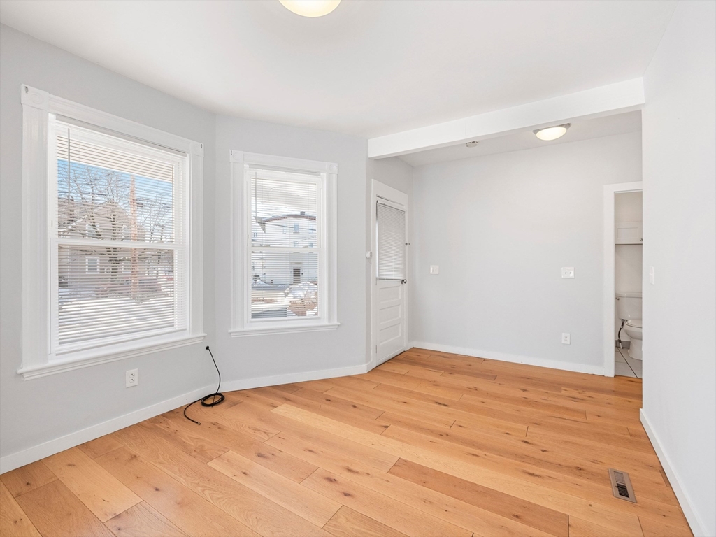 37 Howard Street Lynn, MA 01902 - Photo 8 of 42 a view of an empty room with wooden floor and a window