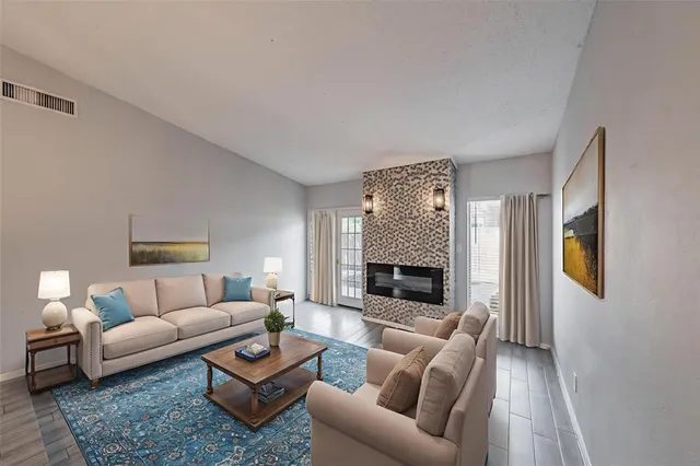 a living room with furniture flat screen tv and a fireplace