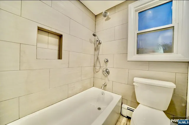 a bathroom with a toilet and a bathtub