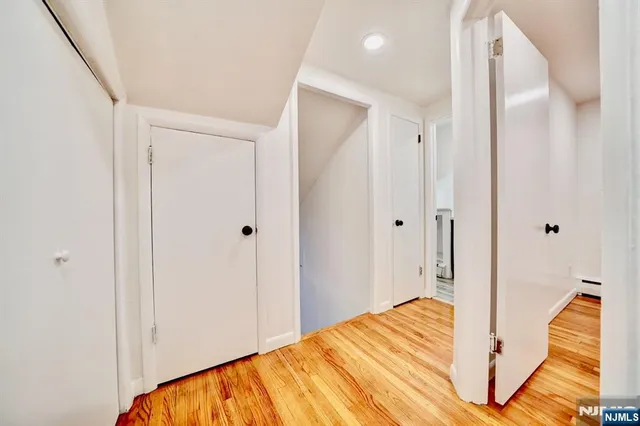 a view of a bedroom with wooden floor