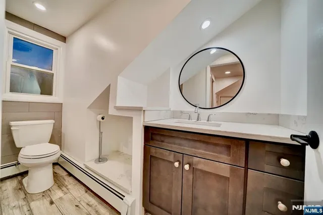 a bathroom with a toilet sink and mirror