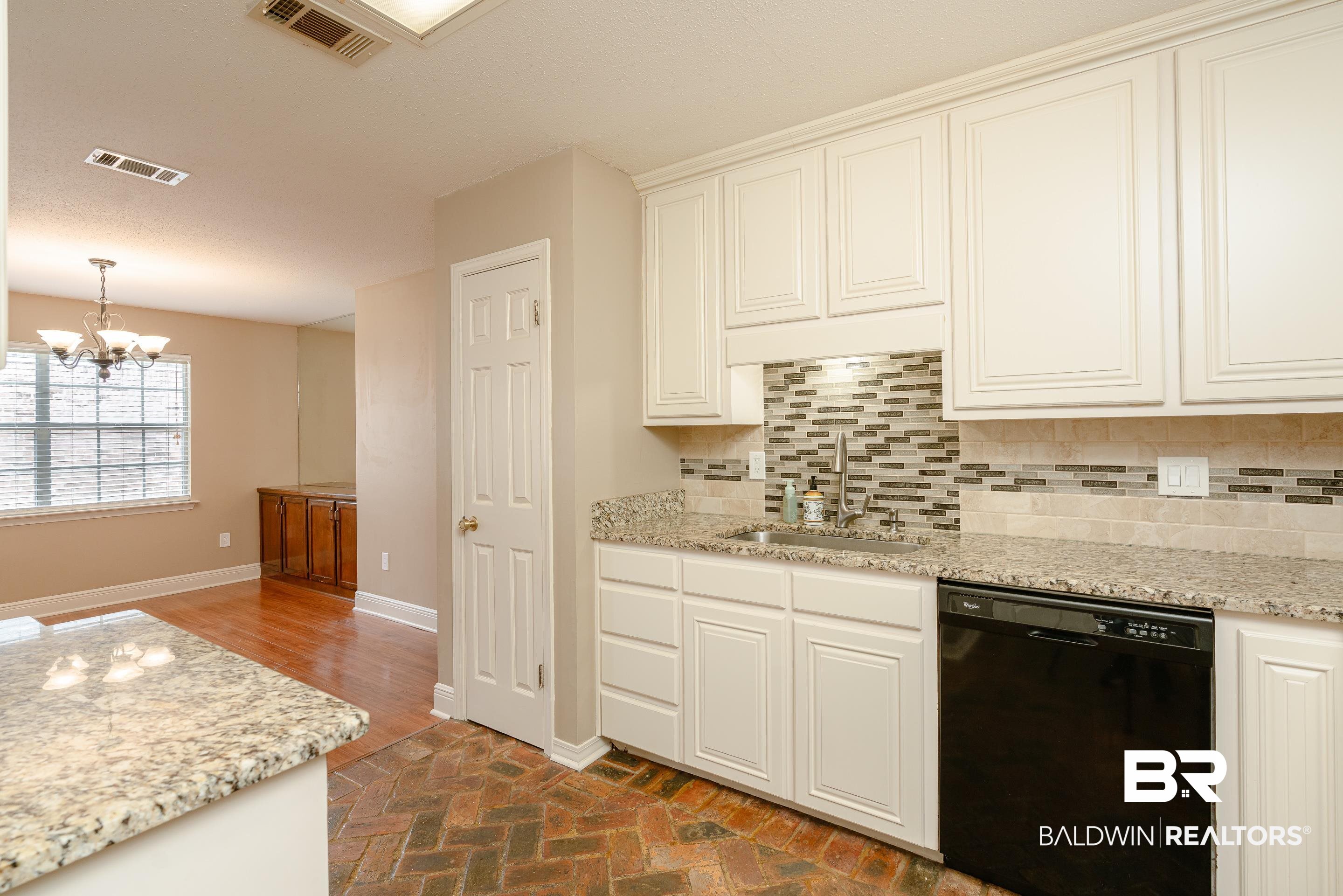 23 Old Mill Court Mobile, AL 36608 - Photo 16 of 37 Kitchen with white cabinetry, a chandelier, dishwasher, backsplash, and sink