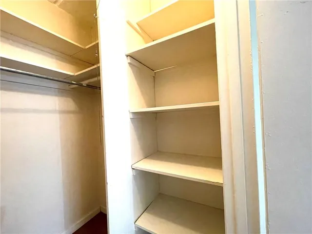 a kitchen with granite countertop white cabinets and a sink