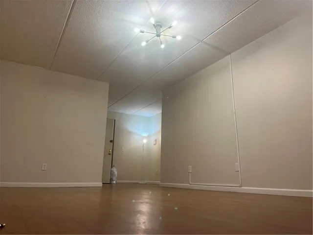 an empty room with a empty space and windows