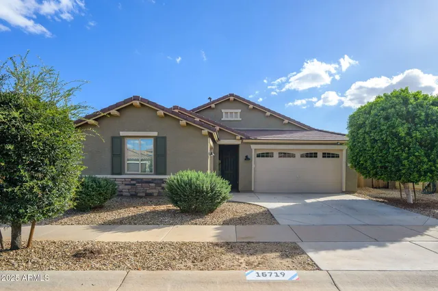 a front view of a house with a yard and garage
