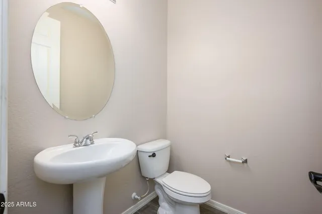 a bathroom with a sink a mirror and a toilet
