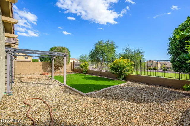 a view of a house with a yard and pathway