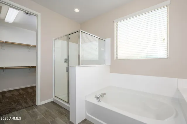 a bathroom with a bathtub and a shower
