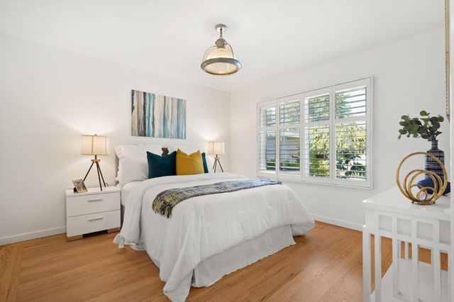 a bedroom with bed and a window