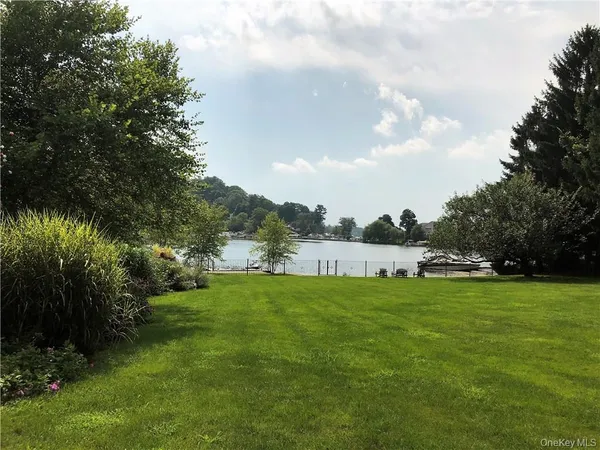 a view of a garden with a house in the background