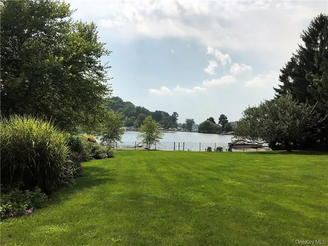 a view of a garden with a house in the background