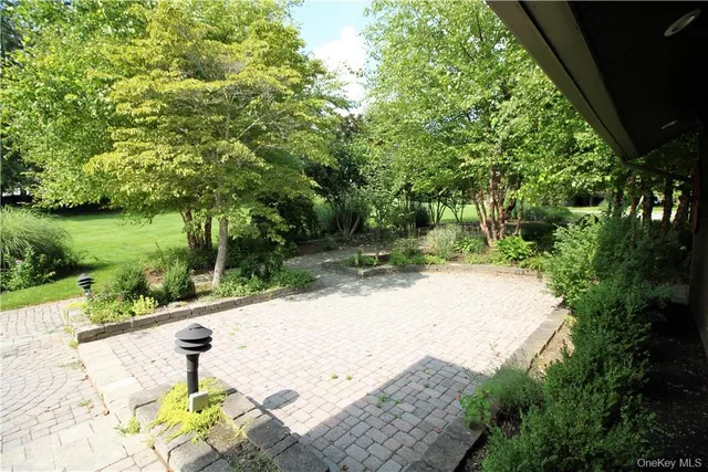a view of a garden with an outdoor seating