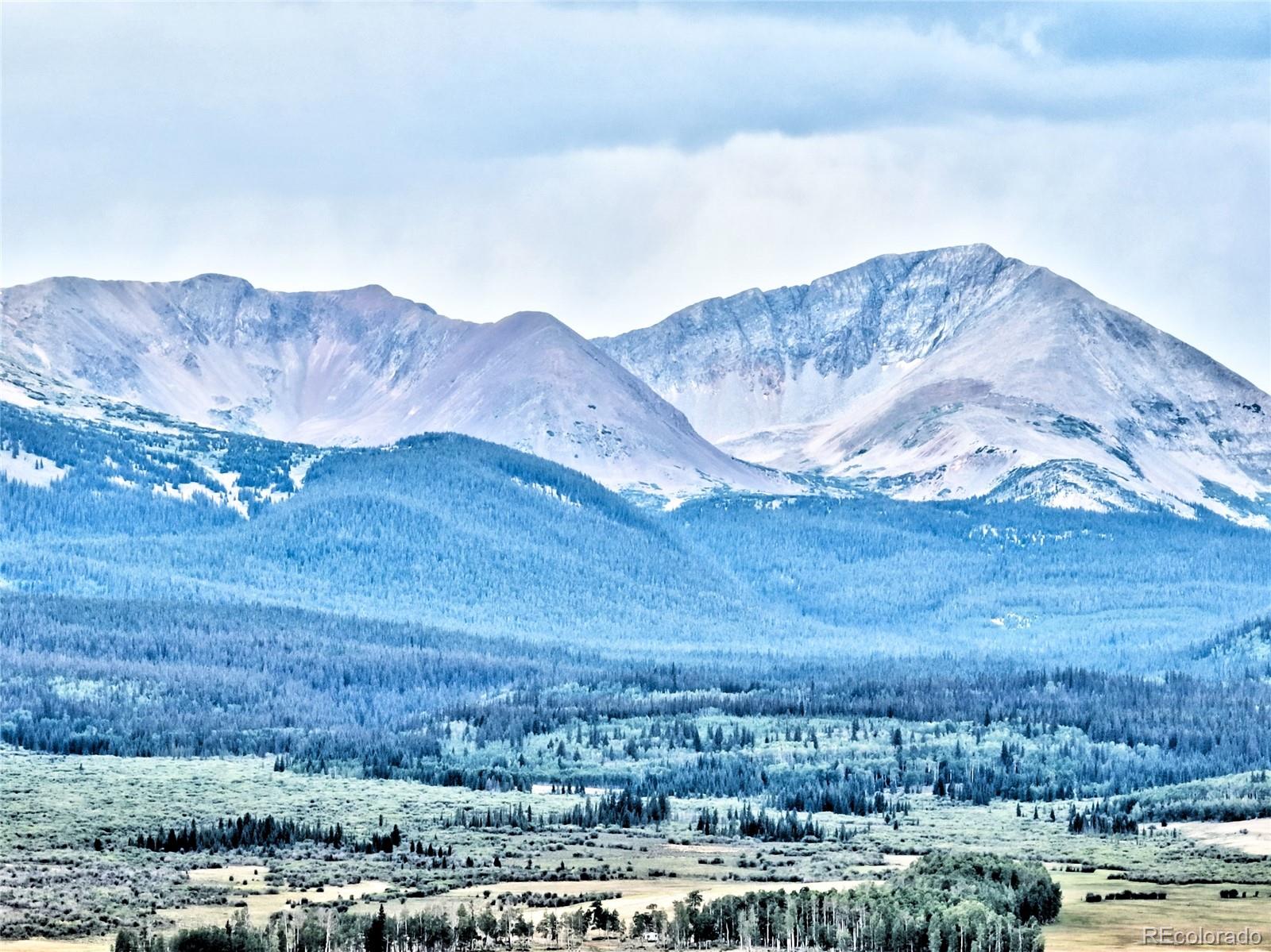 528 Glacier Peak View Road Jefferson, CO 80456 - Photo 21 of 44 a view of a house with a mountain and a yard
