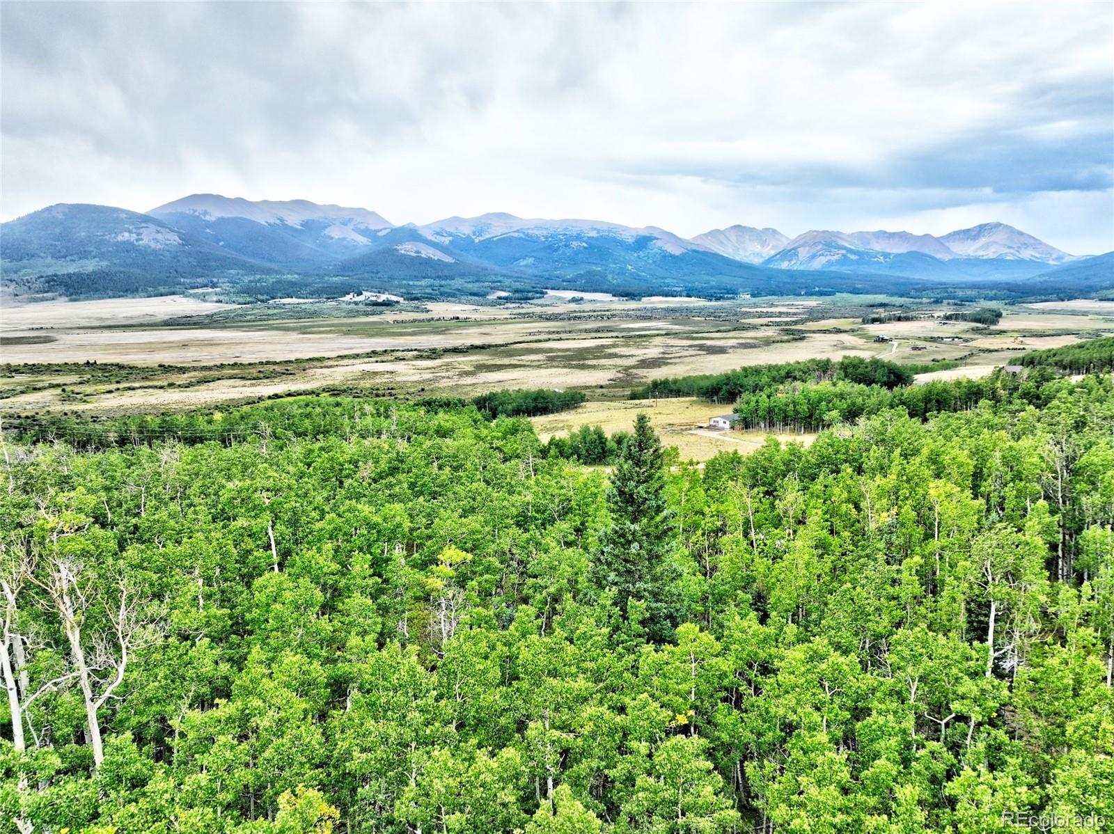 528 Glacier Peak View Road Jefferson, CO 80456 - Photo 10 of 44 a view of a lush green hillside and a building in the background