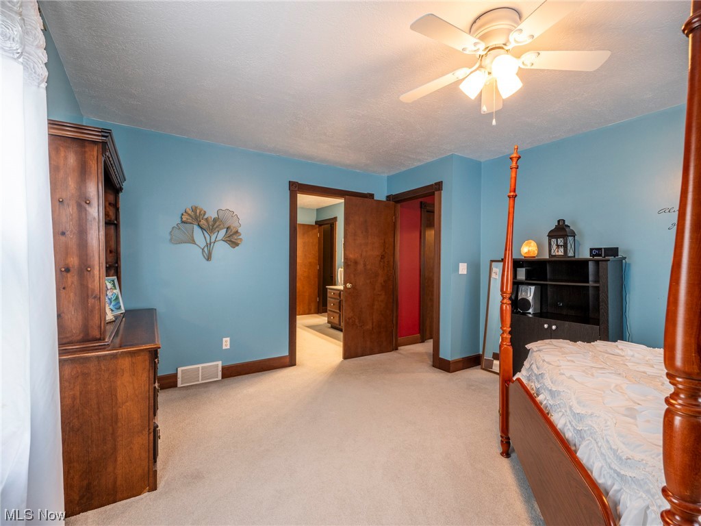 9452 Pleasant Hill Road Northwest Dundee, OH 44624 - Photo 22 of 35 Bedroom with a textured ceiling, light carpet, and ceiling fan