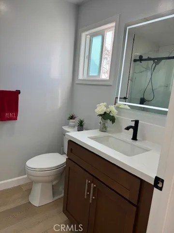 a bathroom with a sink toilet and mirror