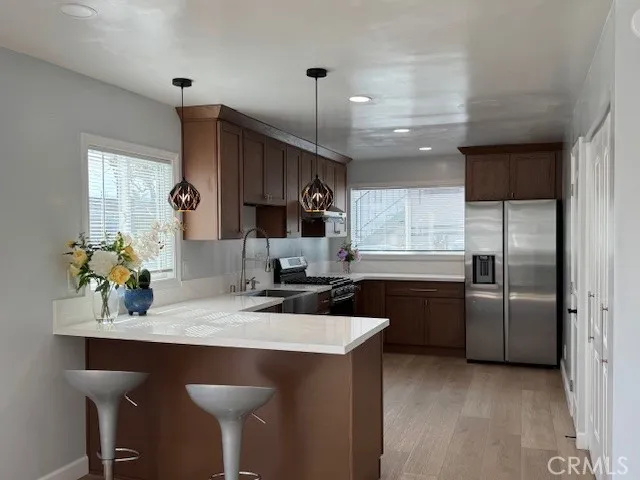 a kitchen with granite countertop a sink cabinets and stainless steel appliances