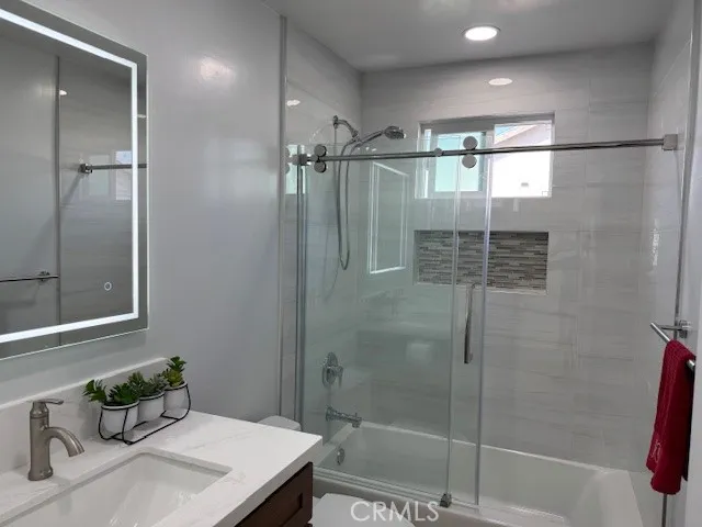 a bathroom with a shower and a sink