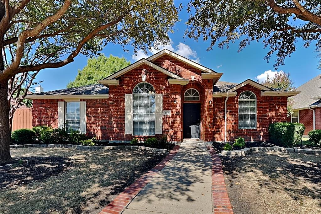 Ranch-style home featuring brick siding