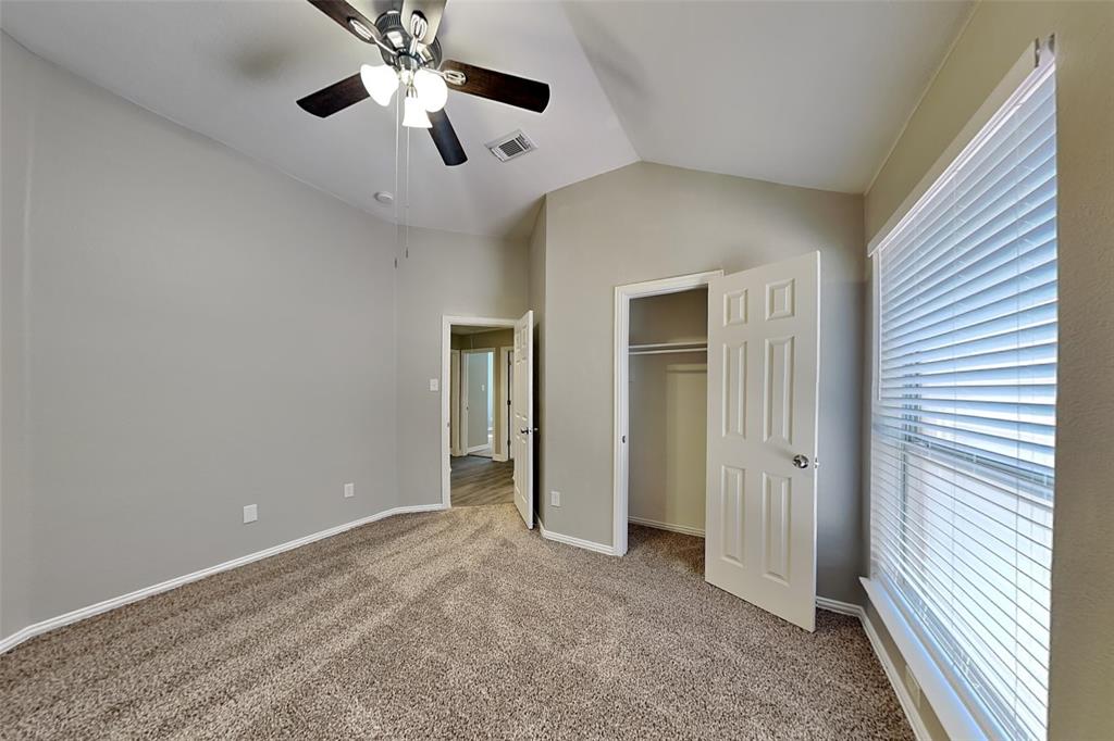 1703 Travis Court Allen, TX 75002 - Photo 13 of 21 Unfurnished bedroom featuring lofted ceiling, carpet floors, ceiling fan, and a closet