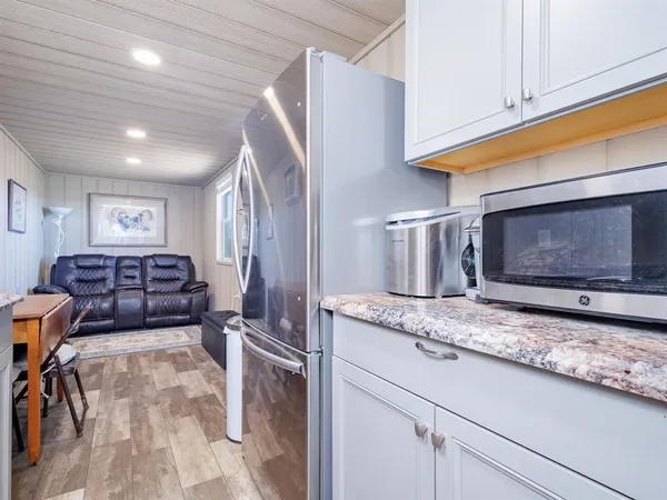 a kitchen with stainless steel appliances granite countertop a sink and cabinets