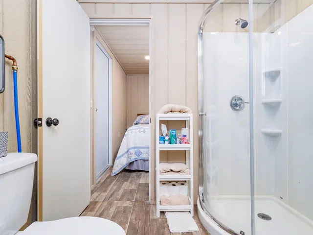 a bed sitting in a bedroom next to a window