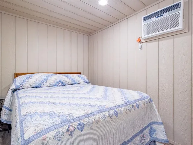 a bedroom with a bed and a mirror