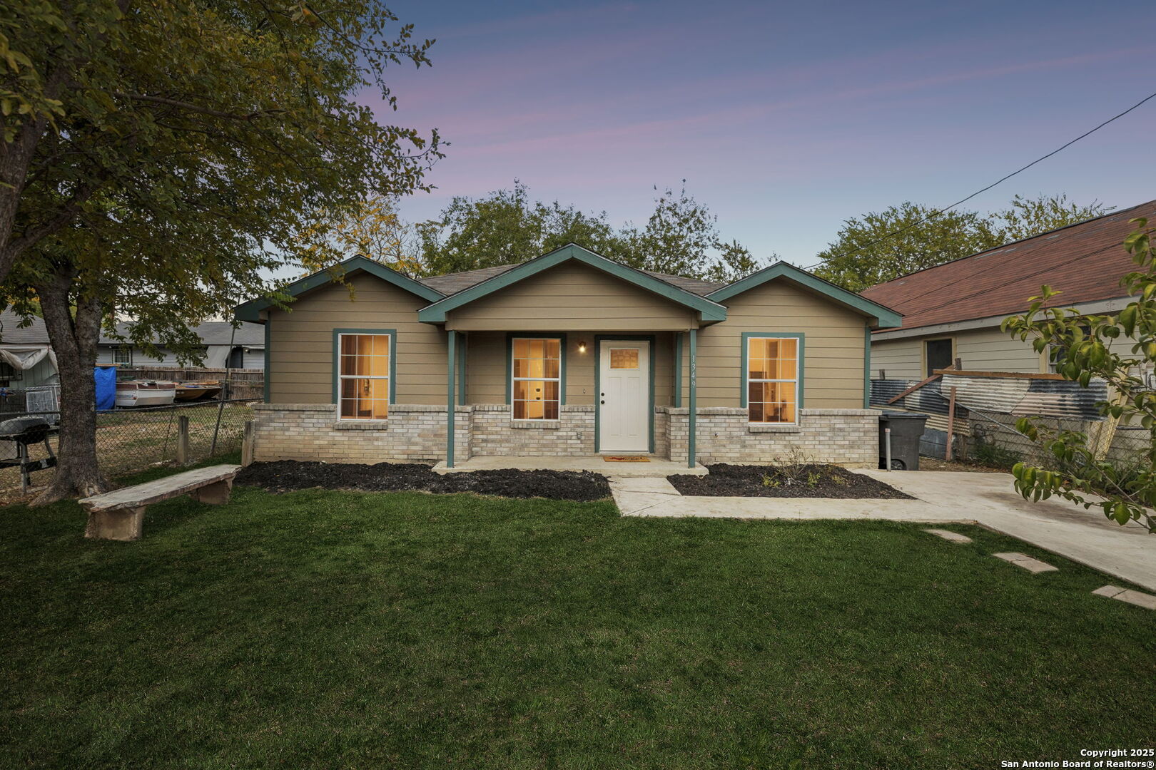 a front view of a house with a garden and yard