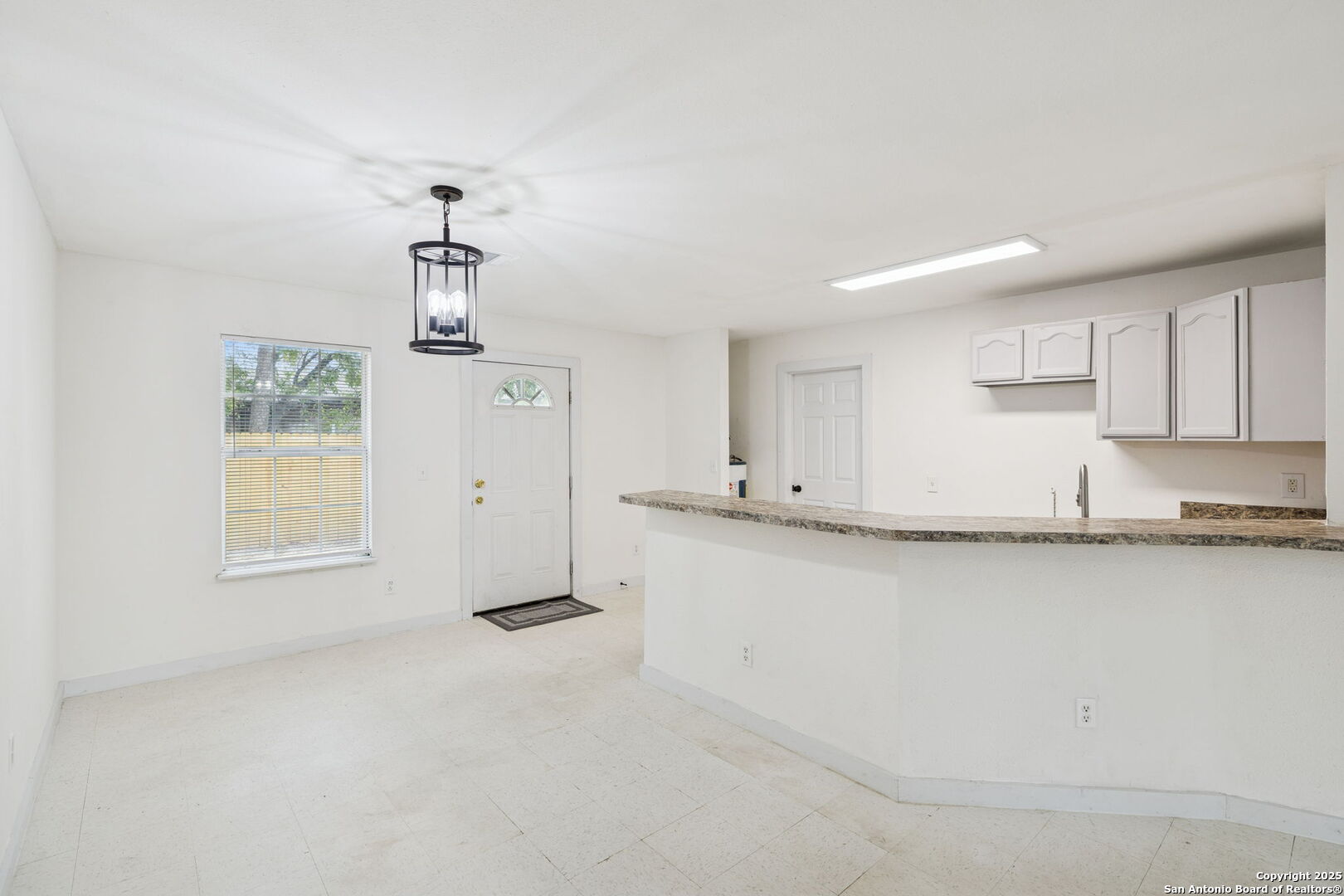 1349 Rivas Street San Antonio, TX 78207 - Photo 13 of 35 a kitchen with granite countertop white cabinets and a sink