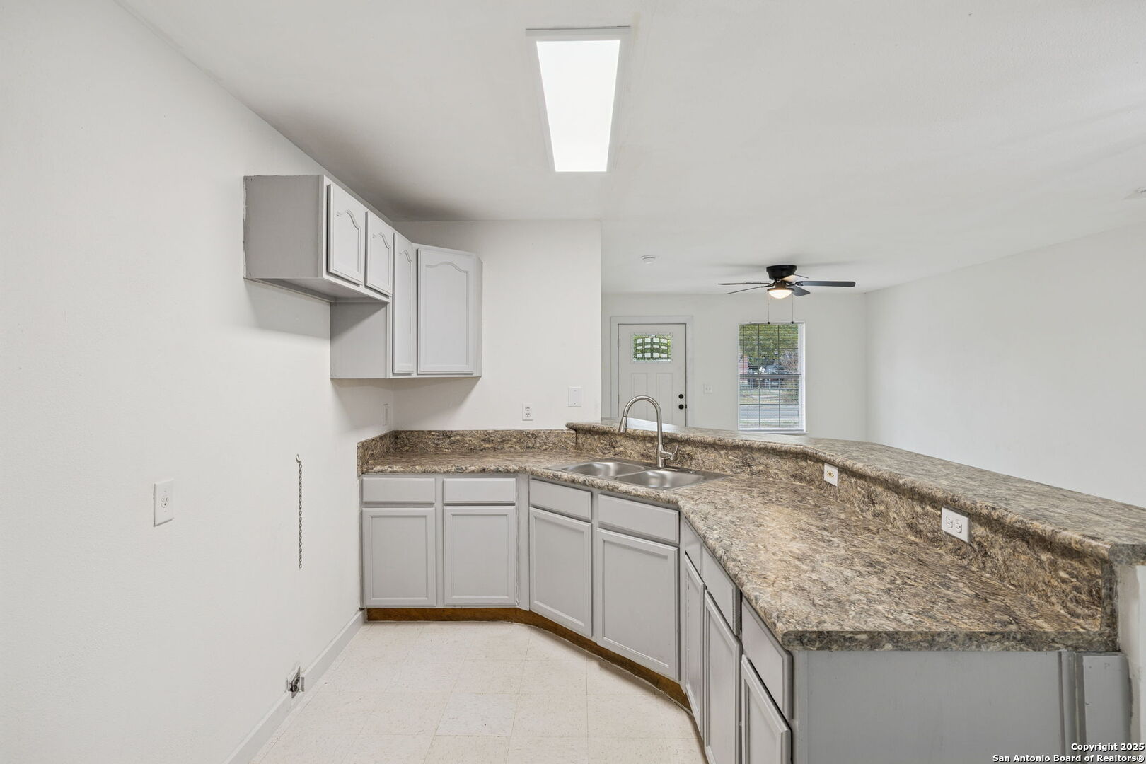 1349 Rivas Street San Antonio, TX 78207 - Photo 17 of 35 a kitchen with granite countertop a sink stove and cabinets