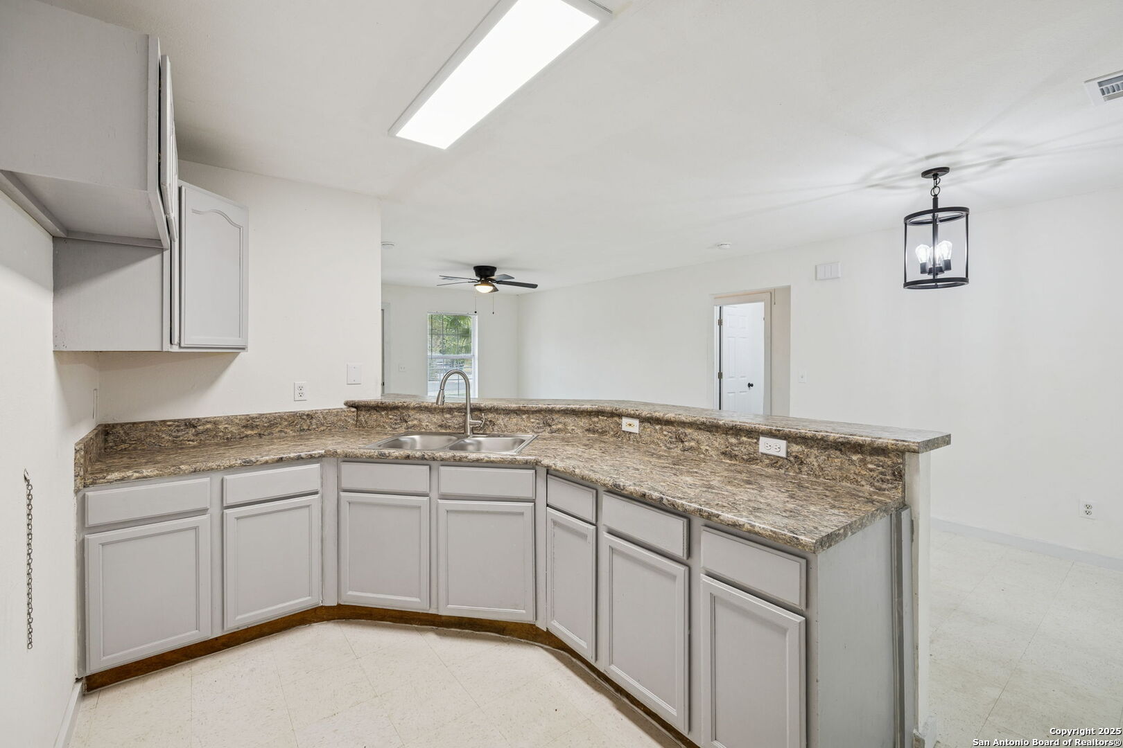 1349 Rivas Street San Antonio, TX 78207 - Photo 18 of 35 a kitchen with a sink and cabinets