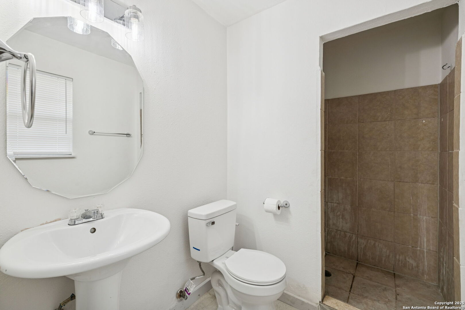 1349 Rivas Street San Antonio, TX 78207 - Photo 23 of 35 a bathroom with a sink a toilet and shower