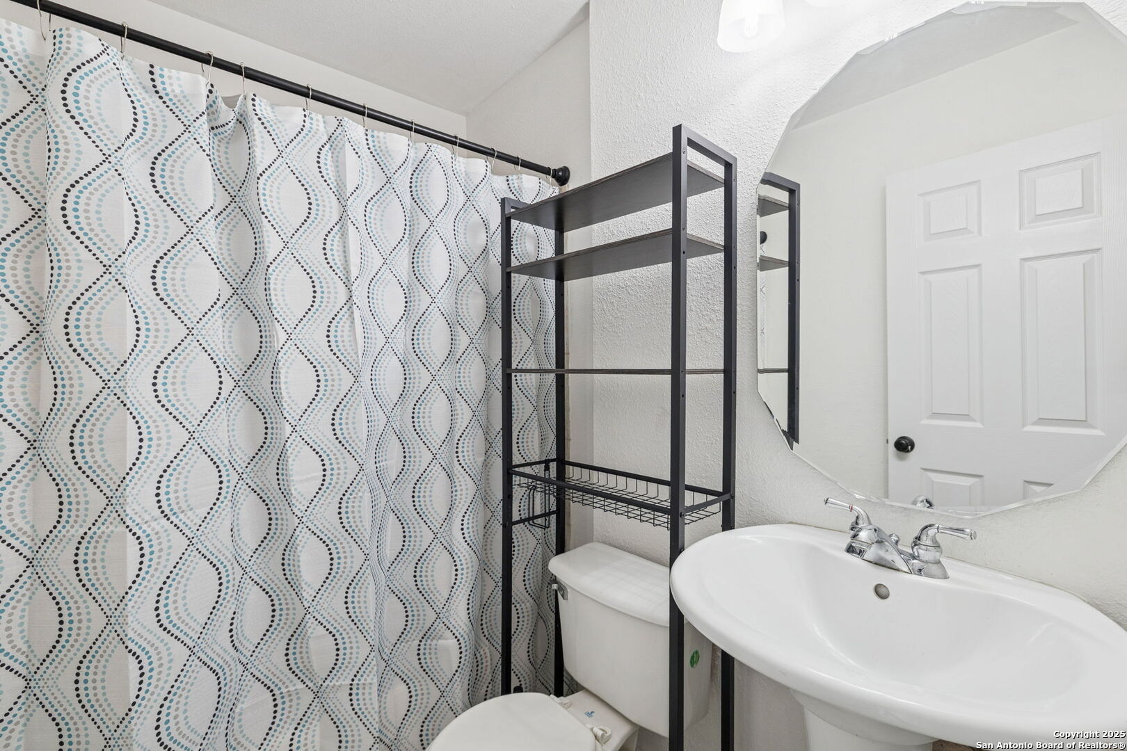 1349 Rivas Street San Antonio, TX 78207 - Photo 26 of 35 a bathroom with a sink and a mirror