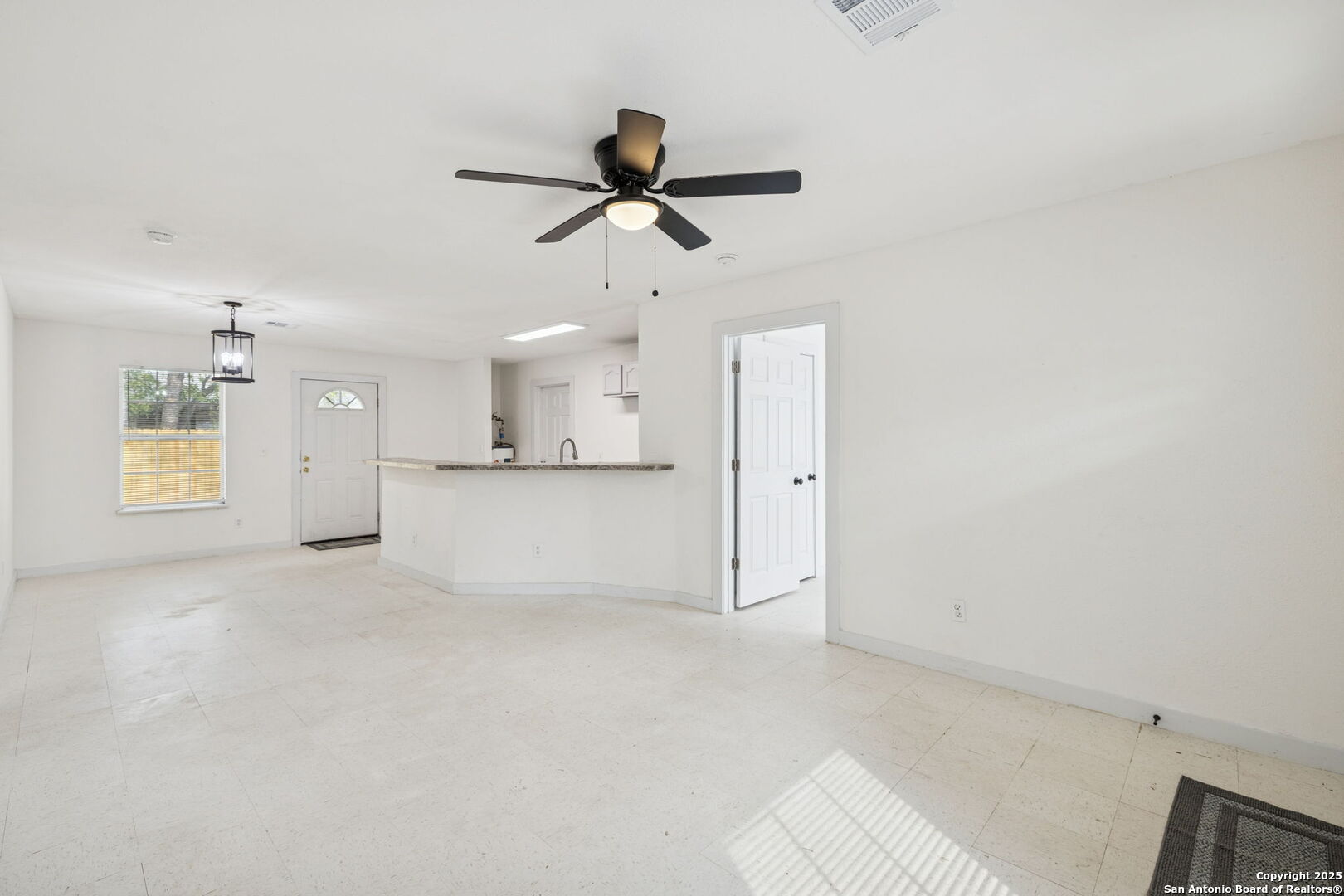 1349 Rivas Street San Antonio, TX 78207 - Photo 9 of 35 a view of empty room with wooden floor and windows