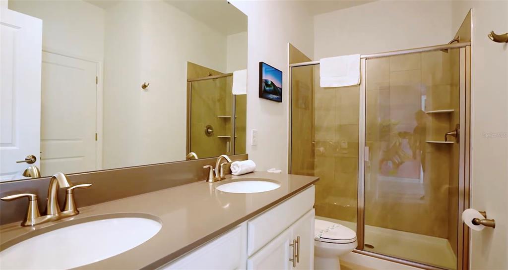 2940 Simile Street Kissimmee, FL 34746 - Photo 12 of 51 a bathroom with a granite countertop sink toilet and shower