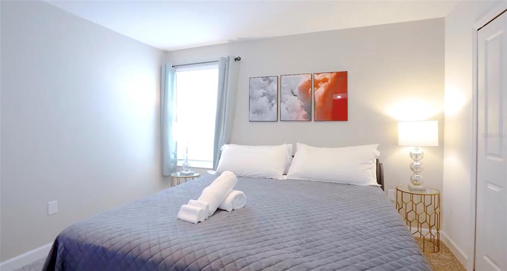 2940 Simile Street Kissimmee, FL 34746 - Photo 13 of 51 a bedroom with a bed and a night lamp