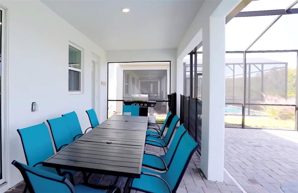 2940 Simile Street Kissimmee, FL 34746 - Photo 16 of 51 a view of a dining room with furniture a potted plant and wooden floor