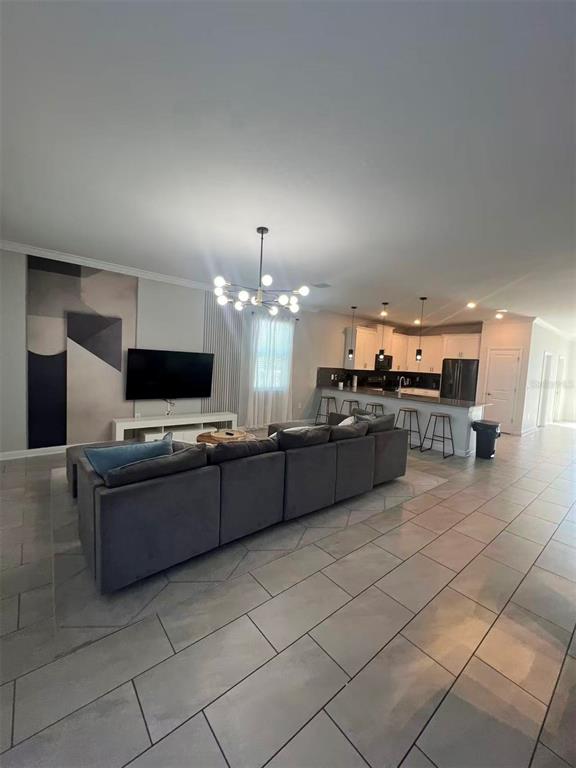 2940 Simile Street Kissimmee, FL 34746 - Photo 33 of 51 a large kitchen with a large counter top and stainless steel appliances