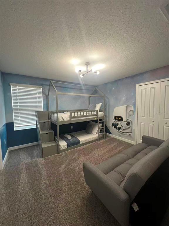 2940 Simile Street Kissimmee, FL 34746 - Photo 40 of 51 a living room with furniture a pool table and a window