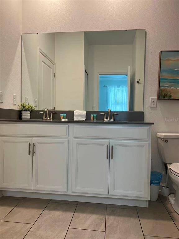 2940 Simile Street Kissimmee, FL 34746 - Photo 50 of 51 a bathroom with a sink and a mirror