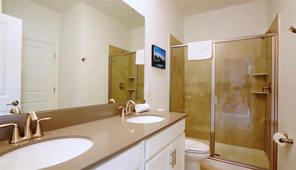 2940 Simile Street Kissimmee, FL 34746 - Photo 51 of 51 a bathroom with a granite countertop sink toilet and shower