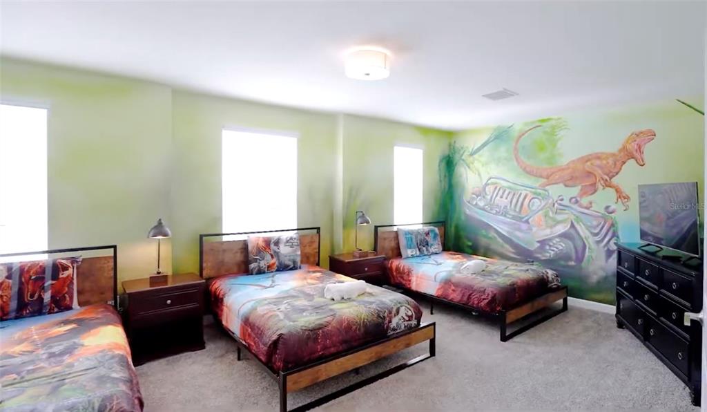 2940 Simile Street Kissimmee, FL 34746 - Photo 8 of 51 a bedroom with two beds and painting on the wall