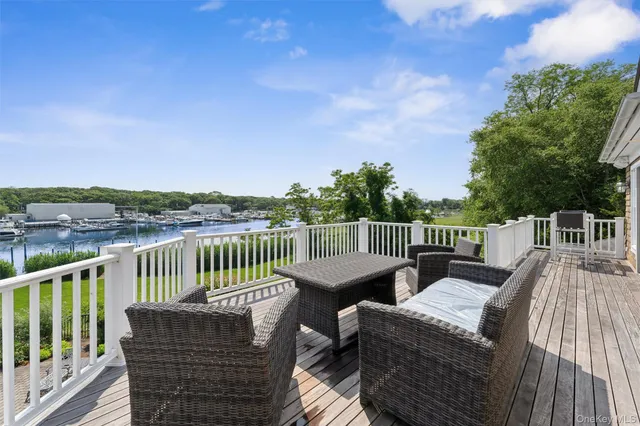 a view of a balcony with wooden floor and outdoor seating