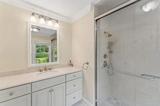 a bathroom with a shower sink and mirror