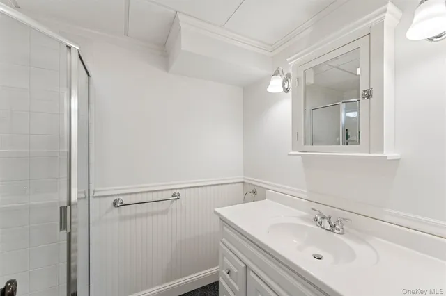 a bathroom with a sink vanity and mirror